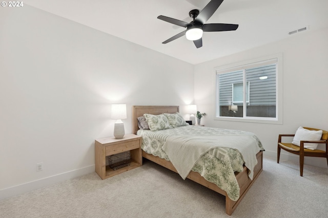 bedroom with ceiling fan and light carpet