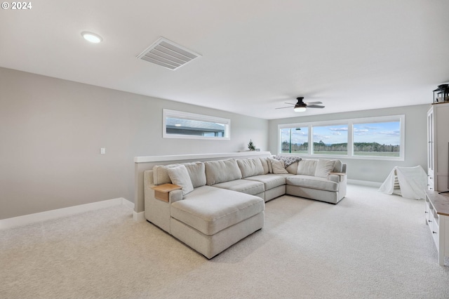 carpeted living room featuring ceiling fan