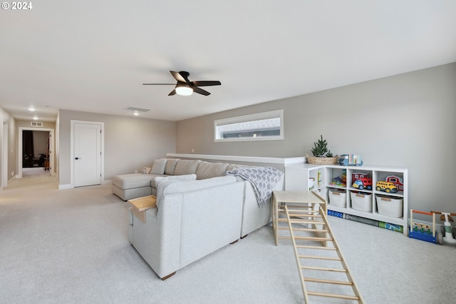 living room featuring light carpet and ceiling fan