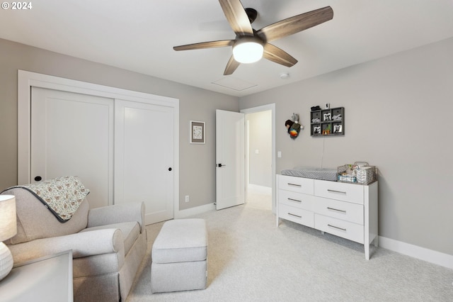 living area featuring light colored carpet and ceiling fan