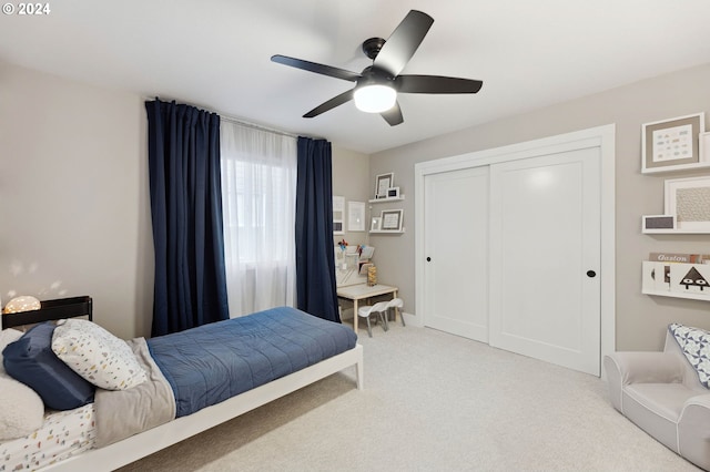 bedroom with light carpet, a closet, and ceiling fan