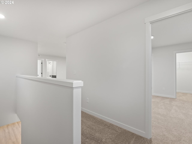 hallway with light colored carpet