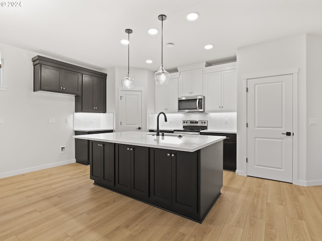 kitchen featuring white cabinets, stainless steel appliances, light hardwood / wood-style floors, and sink