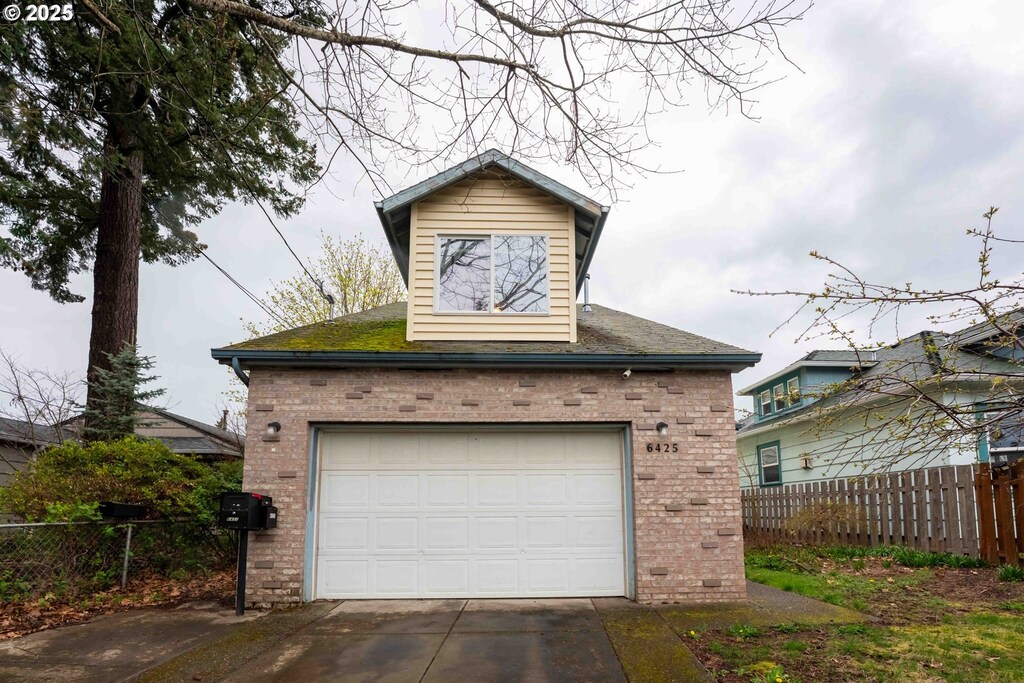 6425 SE Woodstock Blvd, Portland, OR 97206 - garage featuring fence and concrete driveway