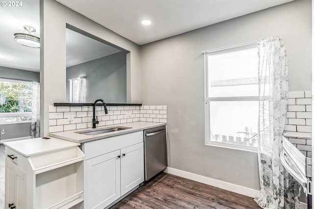 kitchen featuring a sink, white cabinets, light countertops, stainless steel dishwasher, and decorative backsplash