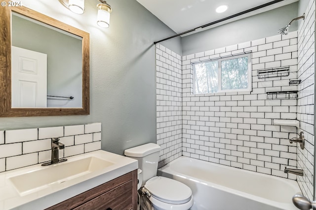 full bathroom featuring tasteful backsplash, a textured wall, toilet, washtub / shower combination, and vanity