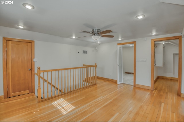 unfurnished room with ceiling fan and light hardwood / wood-style flooring