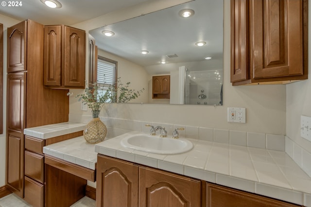 bathroom featuring vanity and a shower with shower door