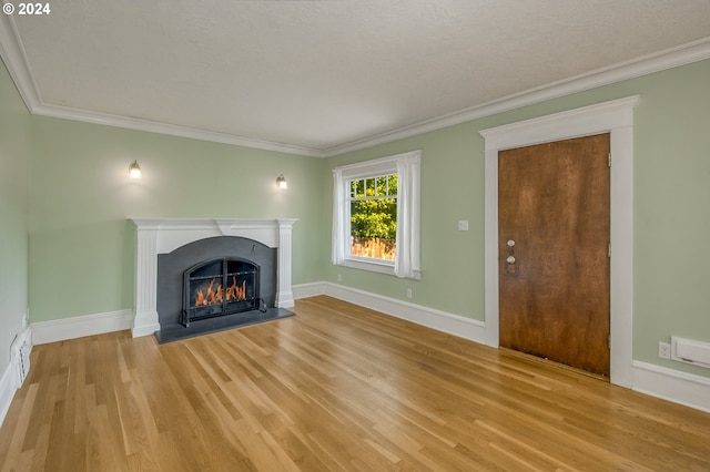 unfurnished living room featuring light hardwood / wood-style flooring and ornamental molding