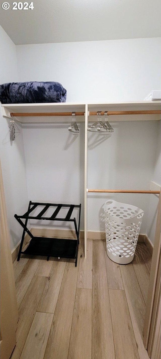 walk in closet featuring hardwood / wood-style flooring