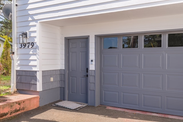 doorway to property with a garage