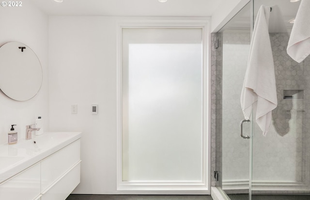 bathroom featuring vanity and an enclosed shower