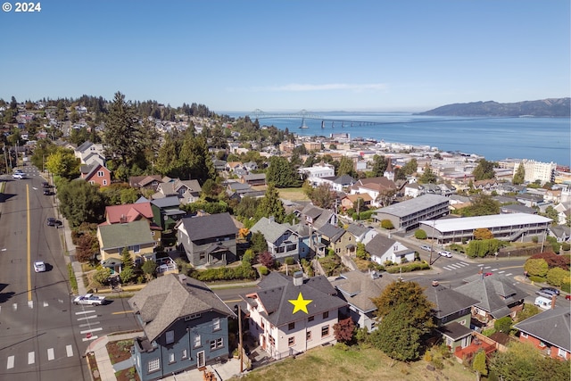 birds eye view of property featuring a water and mountain view