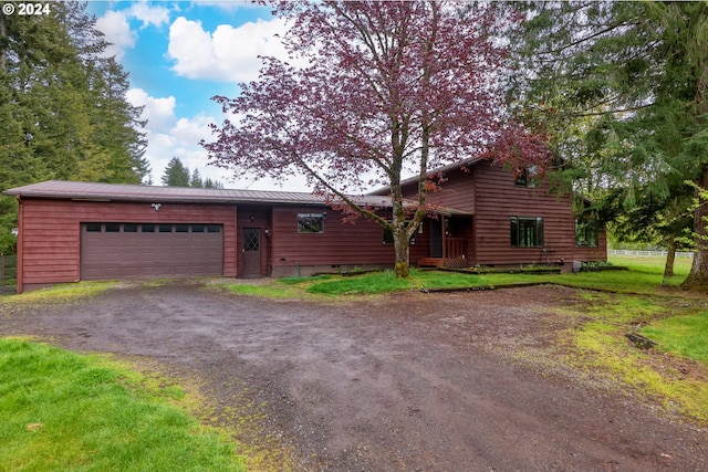 view of front of house with a front yard and a garage