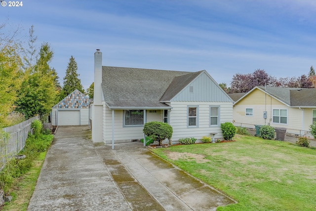 view of front of house featuring an outdoor structure, a front lawn, and a garage