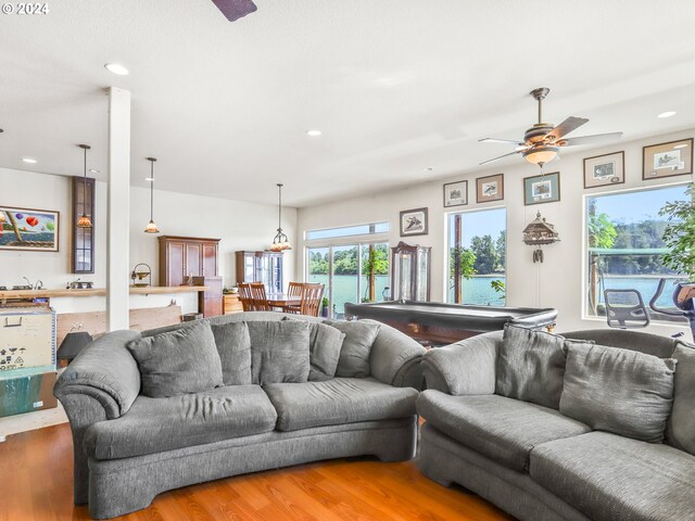 living room featuring a water view, ceiling fan, and hardwood / wood-style floors