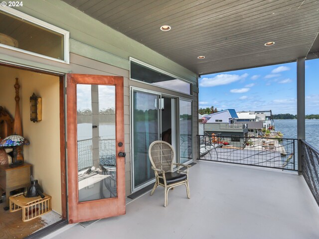 view of patio / terrace with a balcony and a water view