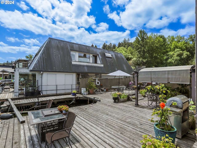 deck with an outbuilding and a grill