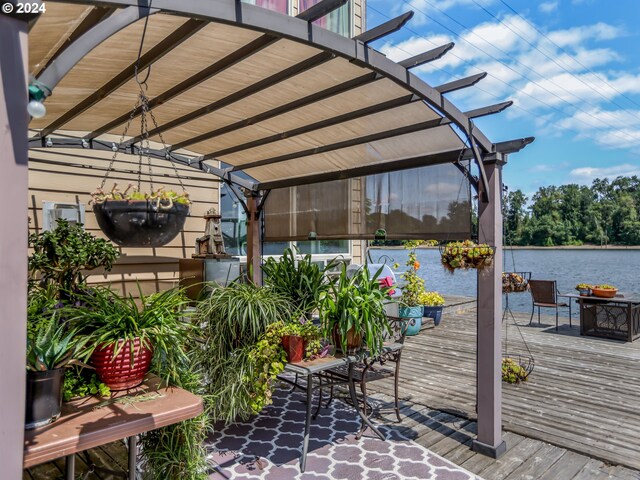 view of patio / terrace with a deck with water view and a pergola