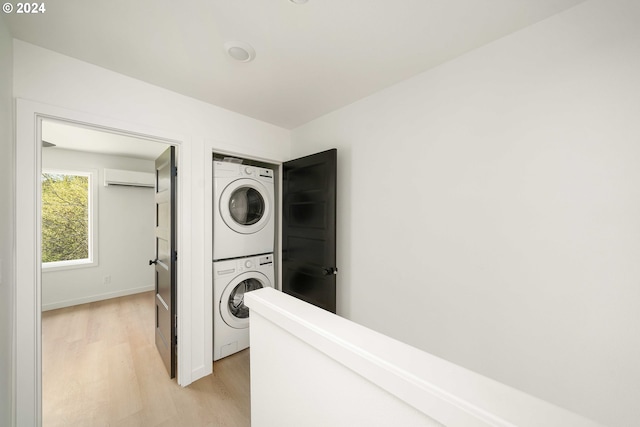 6061 NE Simpson St, Portland, OR 97218 - laundry area with stacked washer and clothes dryer, light wood-style flooring, and a wall mounted air conditioner