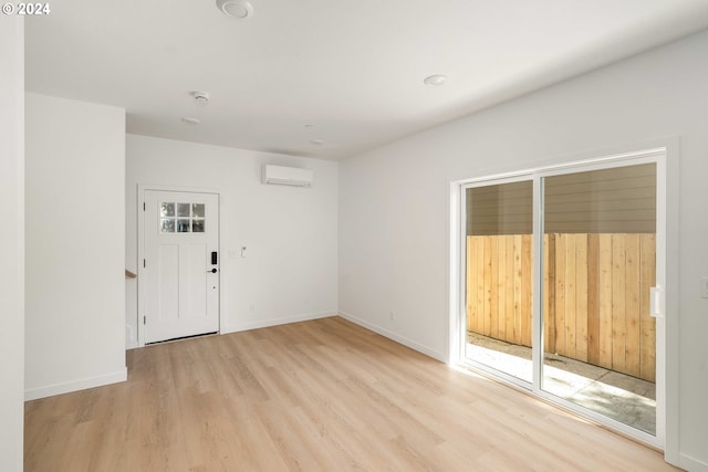 6061 NE Simpson St, Portland, OR 97218 - spare room with wood finished floors, a wall mounted air conditioner, and a smoke detector