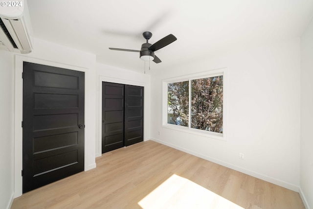 6061 NE Simpson St, Portland, OR 97218 - unfurnished bedroom with a wall mounted air conditioner, a closet, light wood-type flooring, and a ceiling fan