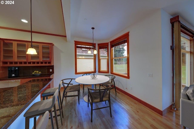 dining room featuring crown molding and light hardwood / wood-style flooring