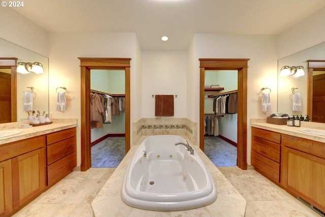 bathroom with tiled bath and vanity