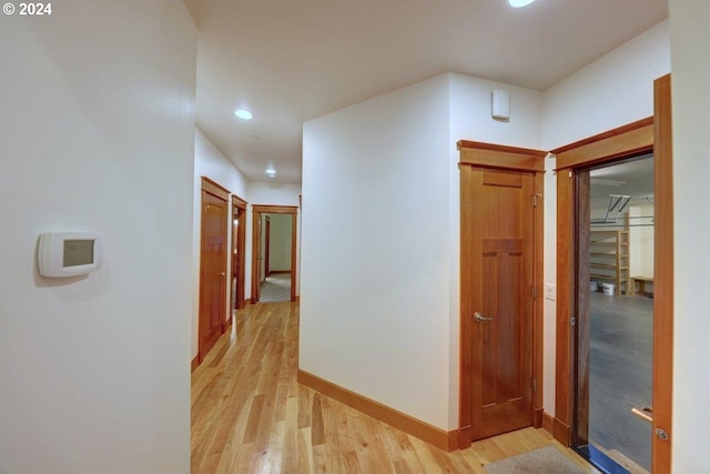 hallway with light hardwood / wood-style flooring