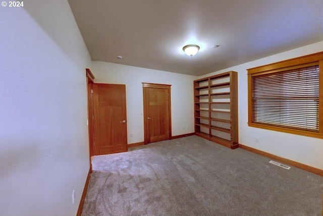 unfurnished bedroom with light colored carpet