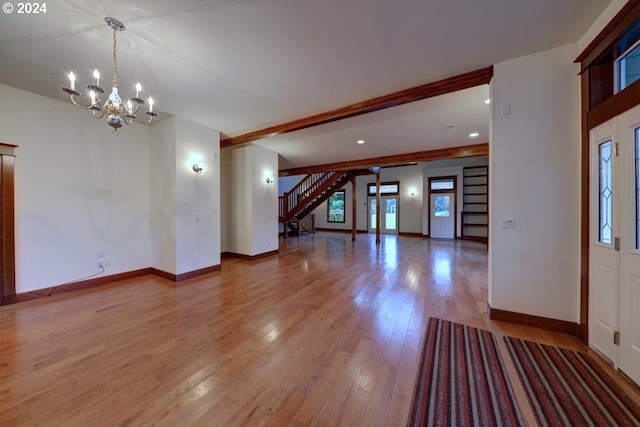 interior space with light wood-type flooring and an inviting chandelier