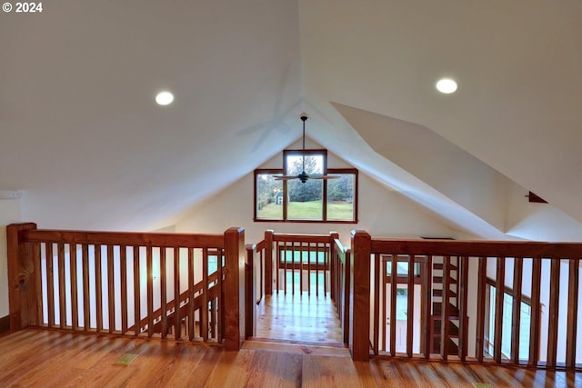 additional living space featuring hardwood / wood-style flooring and vaulted ceiling