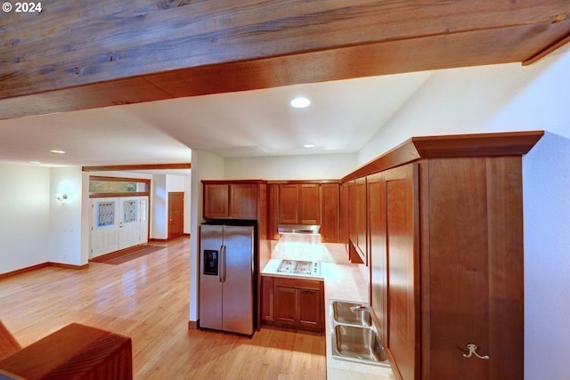 kitchen with stainless steel fridge with ice dispenser, light hardwood / wood-style floors, vaulted ceiling, and white gas stovetop