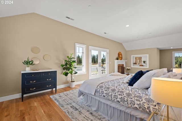 35222 NE 92nd Ct, La Center, WA 98629 - bedroom with vaulted ceiling, light wood-type flooring, access to outside, baseboards, and visible vents