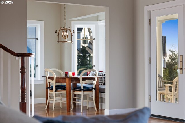 dining space featuring hardwood / wood-style floors and a notable chandelier