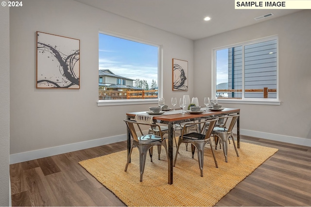 dining area featuring a healthy amount of sunlight and dark hardwood / wood-style flooring