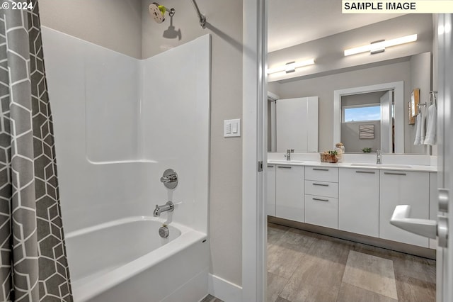 bathroom with vanity, shower / bath combination with curtain, and wood-type flooring