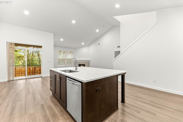 kitchen featuring a center island with sink, plenty of natural light, stainless steel dishwasher, and sink