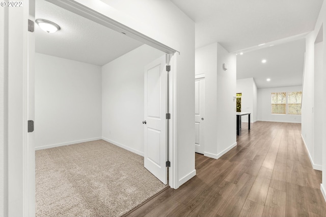 hallway with dark hardwood / wood-style floors