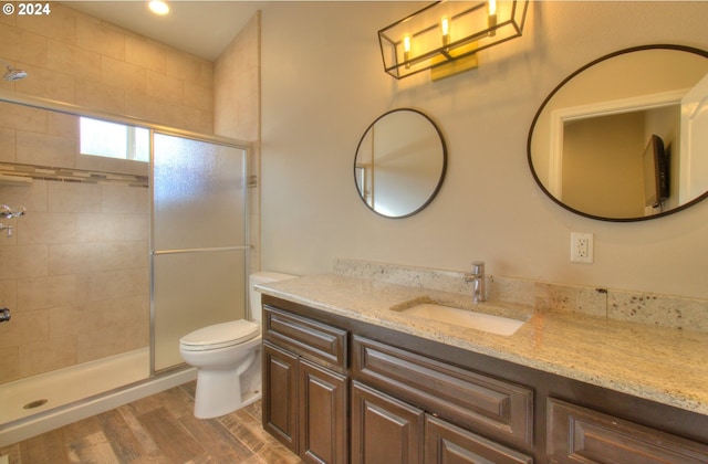 28999 Vizcaino Ct, Gold Beach, OR 97444 - full bathroom featuring a stall shower, vanity, toilet, and wood finished floors