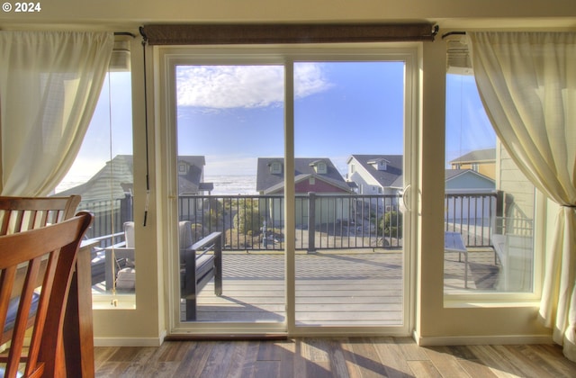 28999 Vizcaino Ct, Gold Beach, OR 97444 - doorway featuring healthy amount of natural light, wood finished floors, baseboards, and a water view