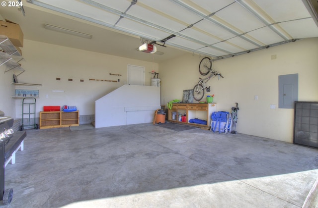 garage with a garage door opener and electric panel