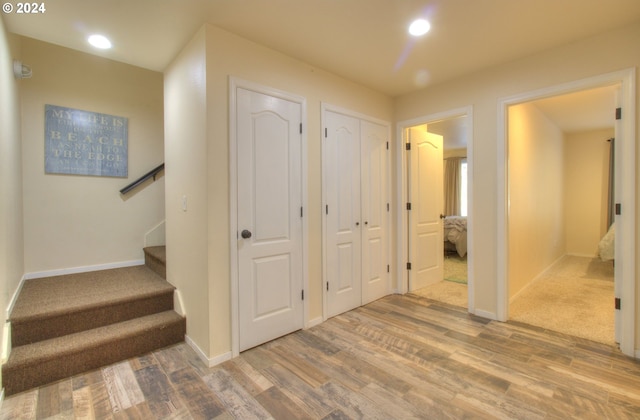 28999 Vizcaino Ct, Gold Beach, OR 97444 - hallway featuring wood finished floors, baseboards, stairs, and recessed lighting