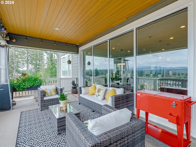 sunroom featuring wooden ceiling and a wealth of natural light