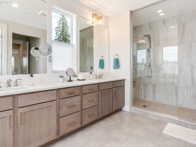 bathroom featuring tiled shower and vanity