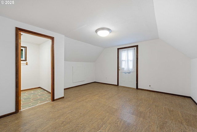 bonus room featuring light hardwood / wood-style floors and lofted ceiling