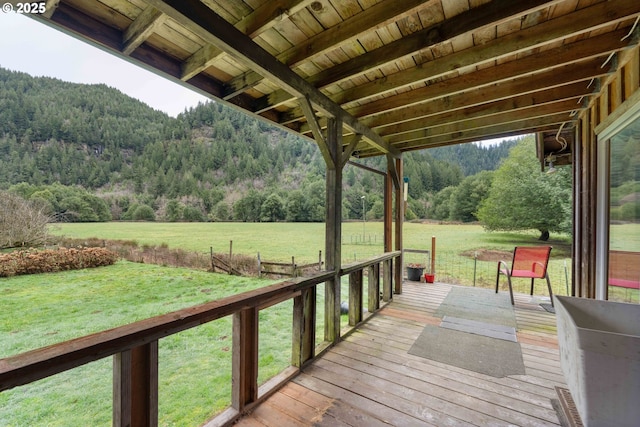 wooden terrace with a lawn and a mountain view