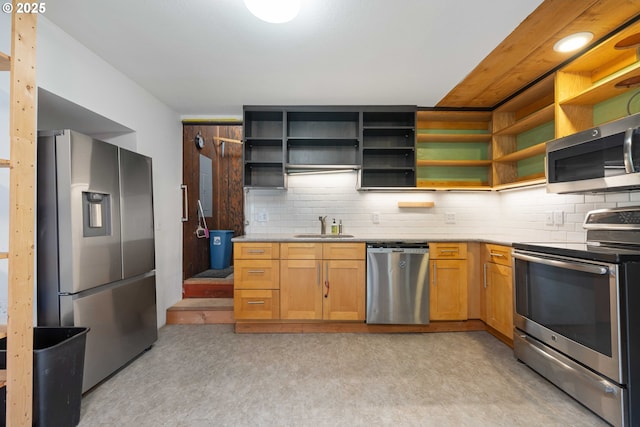 kitchen featuring stainless steel appliances, tasteful backsplash, and sink