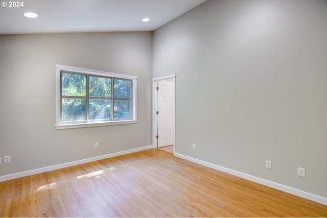 unfurnished room featuring light hardwood / wood-style flooring and high vaulted ceiling