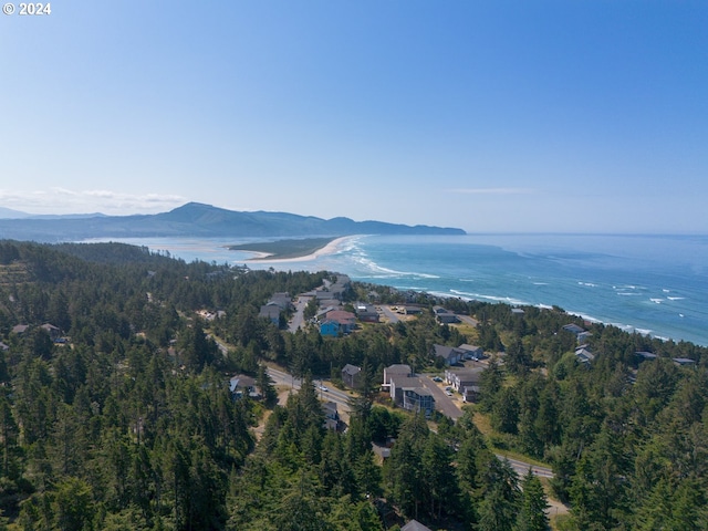 drone / aerial view featuring a water and mountain view